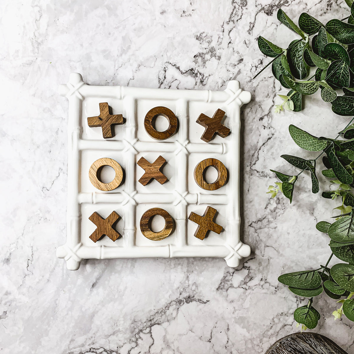 Faux Bamboo Tic Tac Toe game featuring a ceramic board and acacia wood pieces, elegantly designed for decor and play.