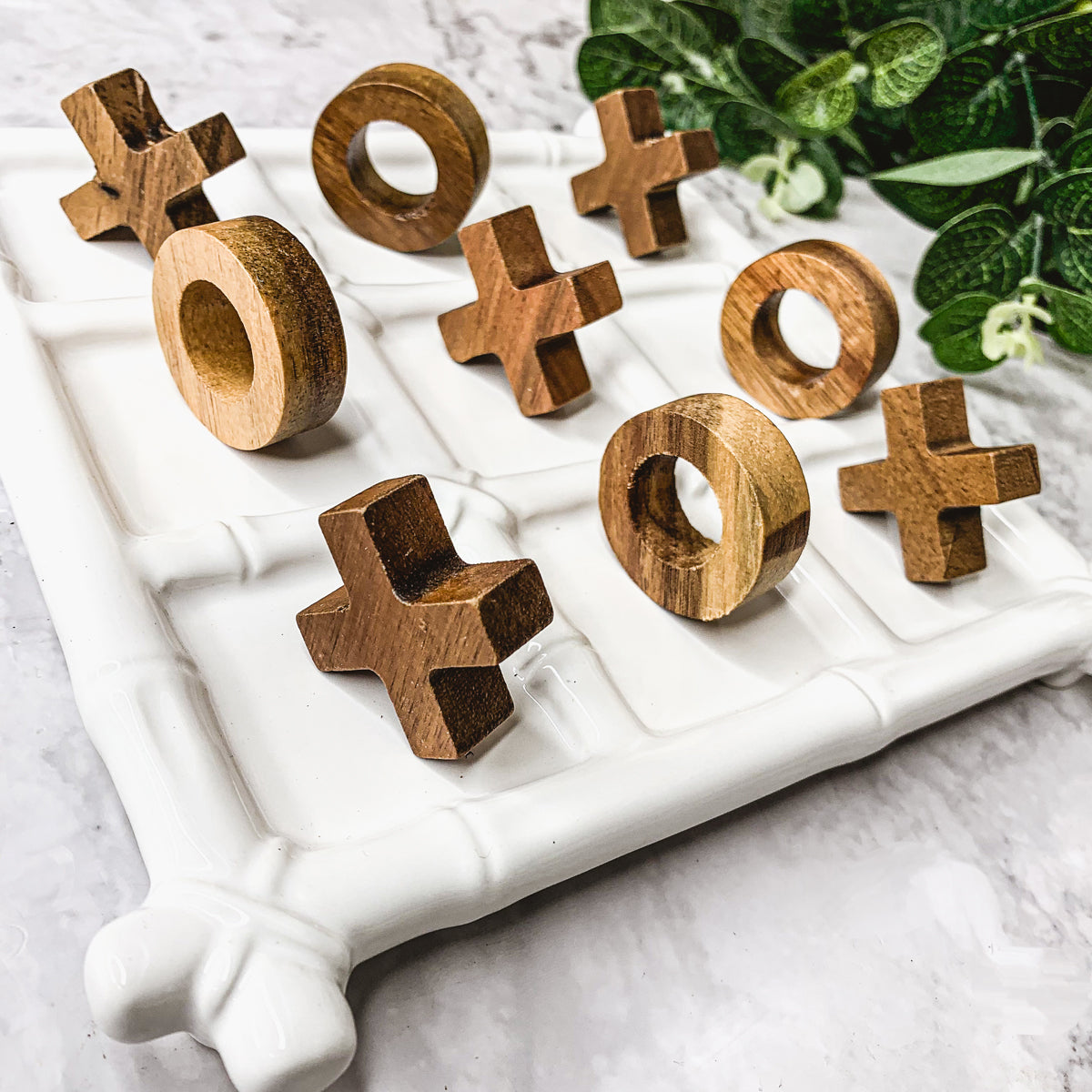 Faux Bamboo Tic Tac Toe game featuring a ceramic board and acacia wood pieces, elegantly designed for decor and play.