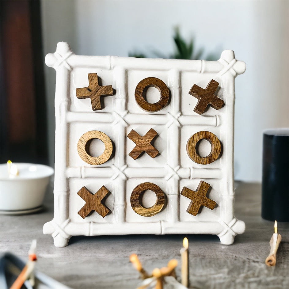 Faux Bamboo Tic Tac Toe game featuring a ceramic board and acacia wood pieces, elegantly designed for decor and play.