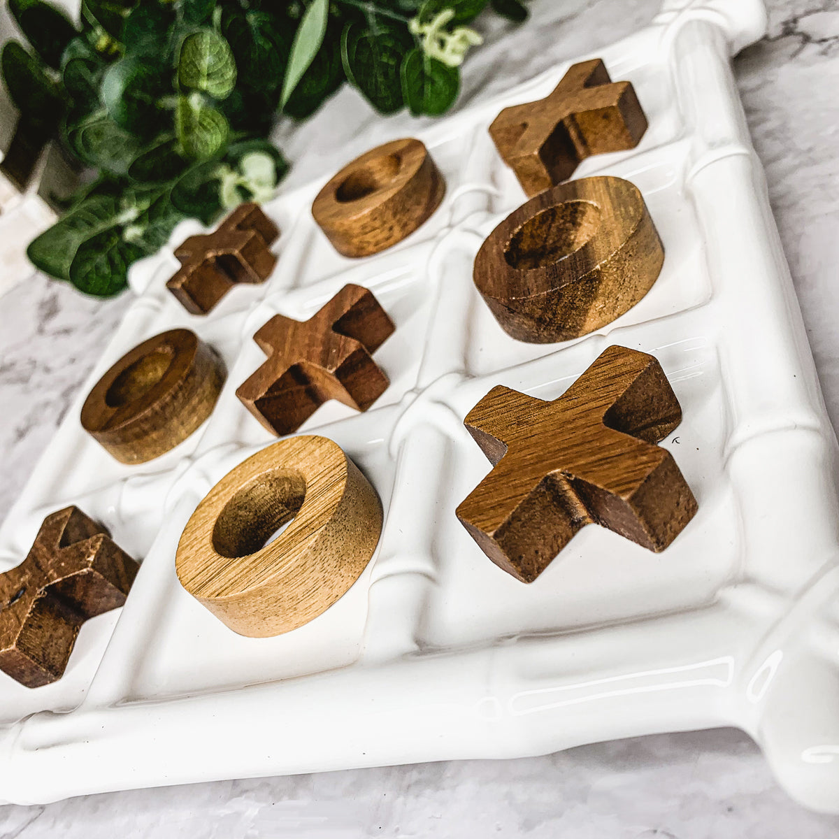 Faux Bamboo Tic Tac Toe game featuring a ceramic board and acacia wood pieces, elegantly designed for decor and play.