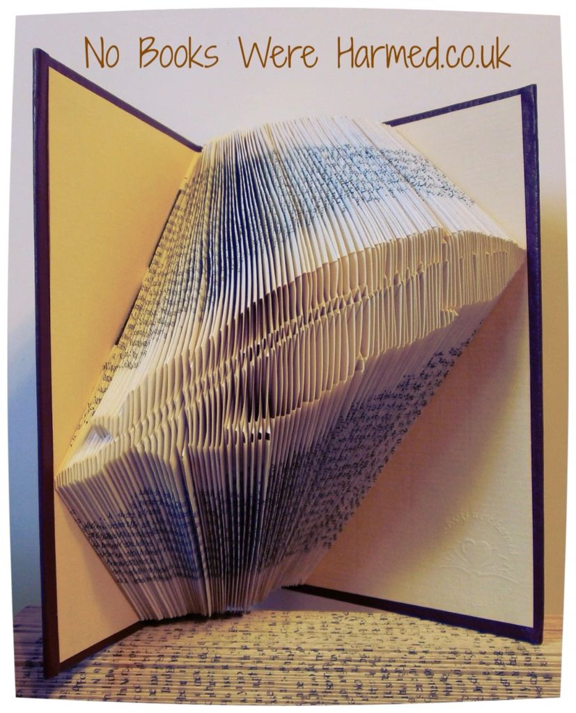 Hand-folded feather art made from vintage books, showcasing intricate designs and unique colors.