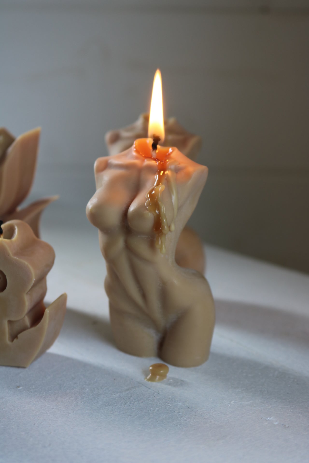 A beautifully crafted Female torso candle in soft cream color, showcasing elegant curves and details, perfect for home decor.