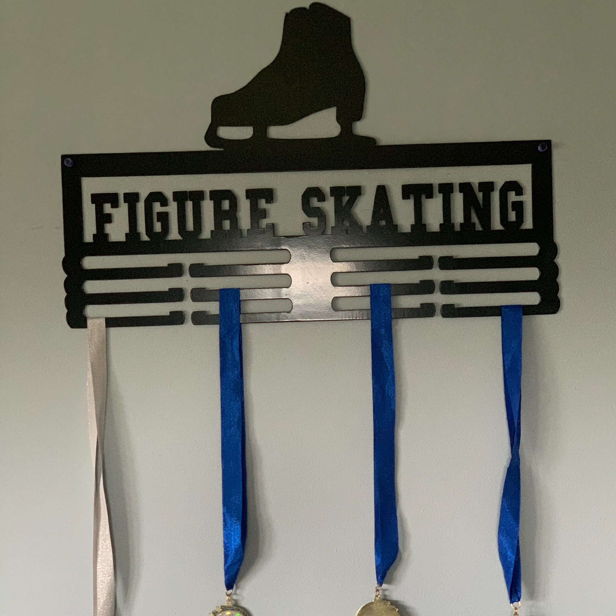 Figure Skater Medal Holder made of 14 gauge steel, featuring a sleek design for displaying ice skating medals.