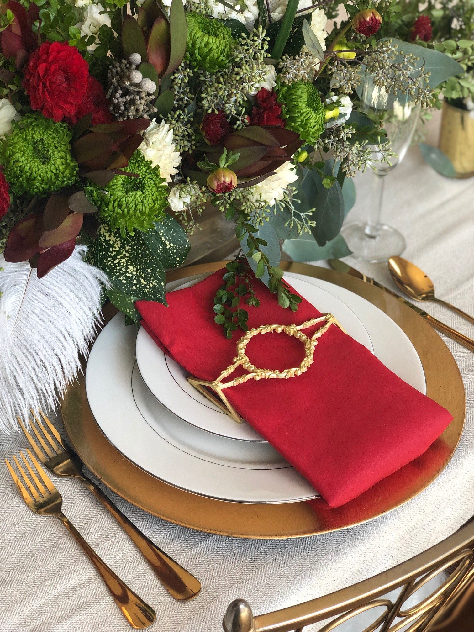 Set of four matte gold filigree napkin wraps elegantly displayed in a stylish box.