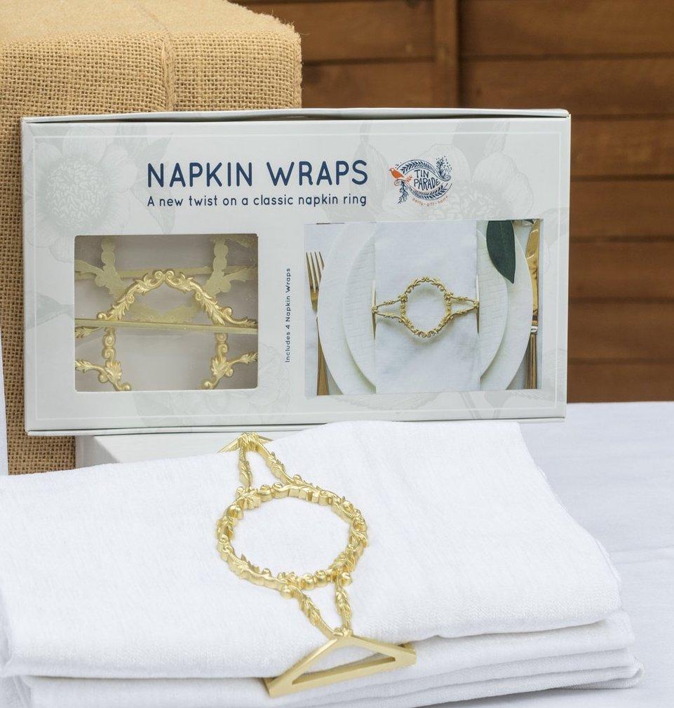 Set of four matte gold filigree napkin wraps elegantly displayed in a stylish box.