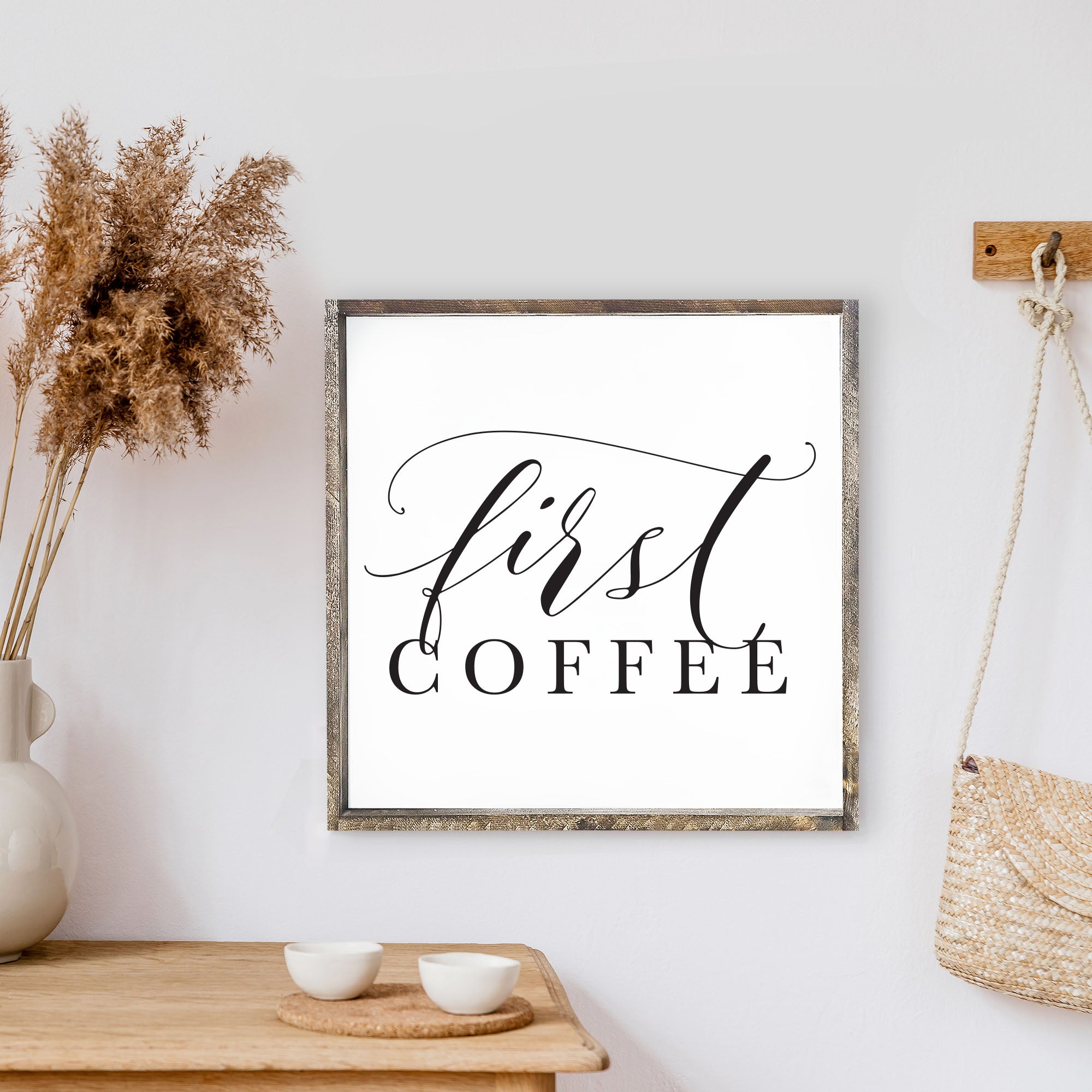 A rustic First Coffee Wood Sign measuring 13x13 inches, featuring a wood-stained pine frame and waterproof black text on a white background.