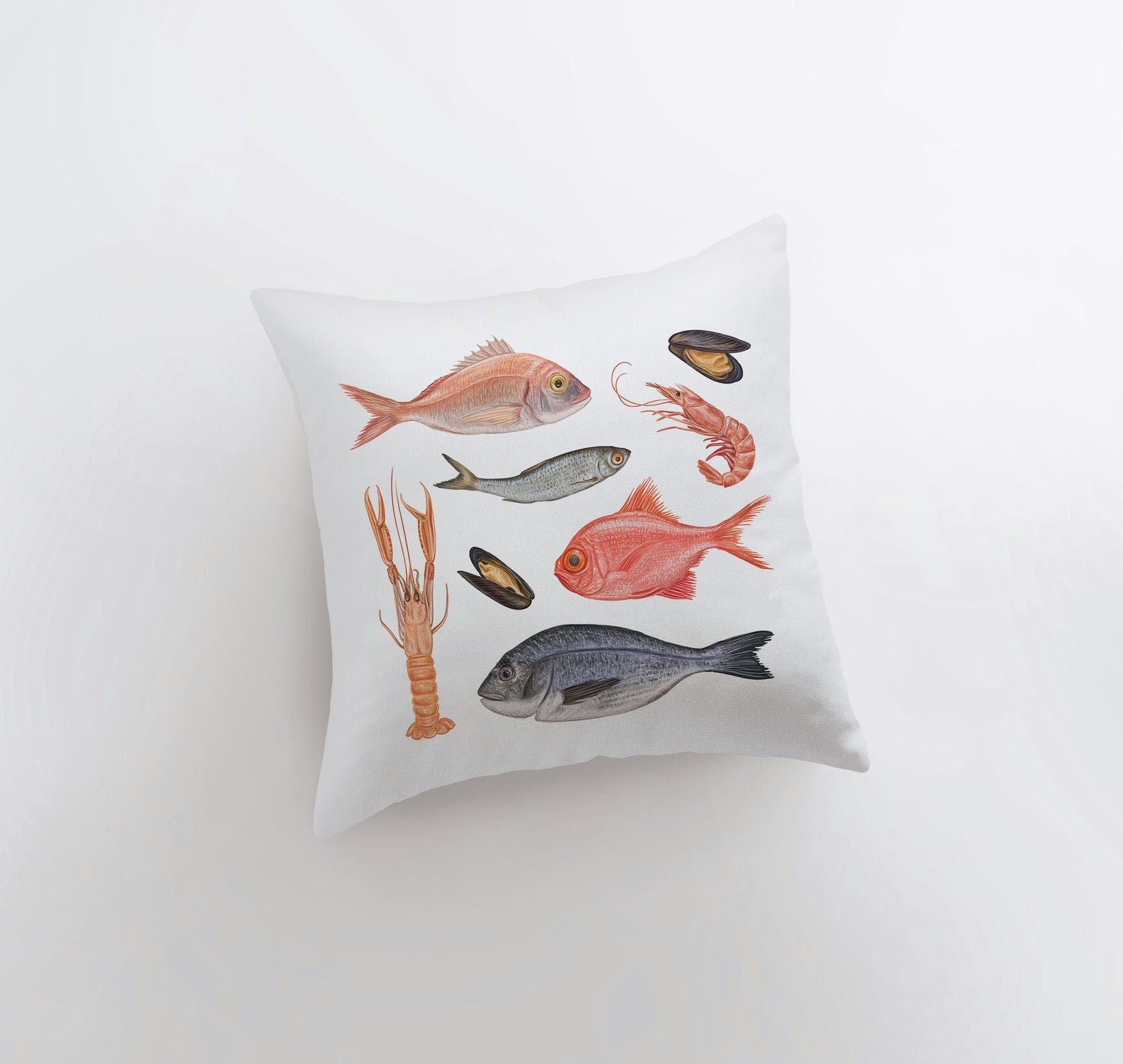 A stylish throw pillow featuring a fish and crustacean pattern, perfect for coastal home decor.