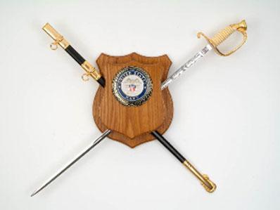 Flag Connections Military Sword Plaque Deluxe made of solid oak, featuring a service emblem and optional personalized engraving.