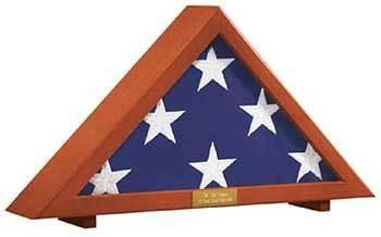 A polished wood and acrylic triangle flag display case with a personalized brass plaque, elegantly showcasing a folded veteran's flag.