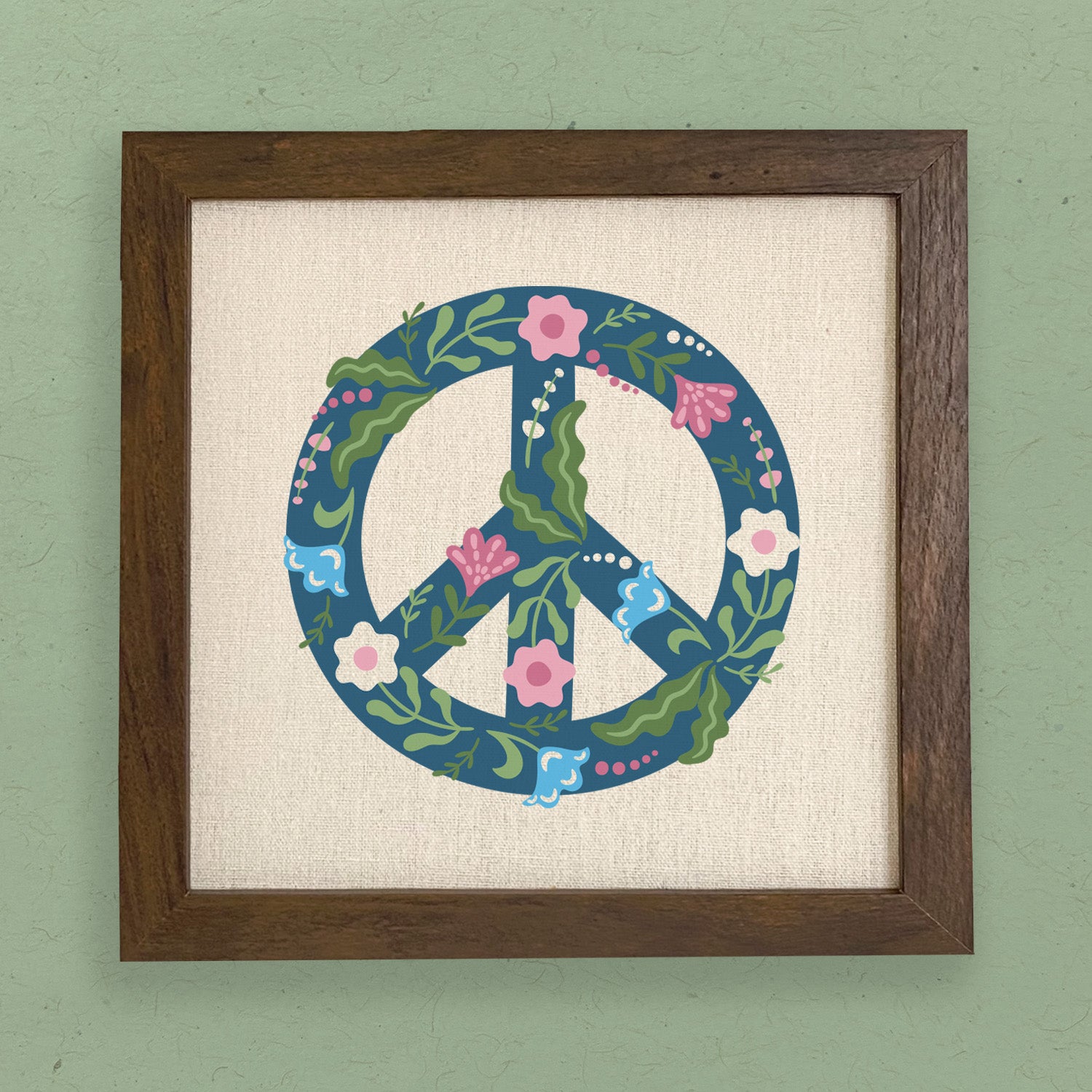 A beautifully framed Floral Peace Sign featuring a vibrant floral design on a neutral linen-look background, available in walnut or white-washed frame.