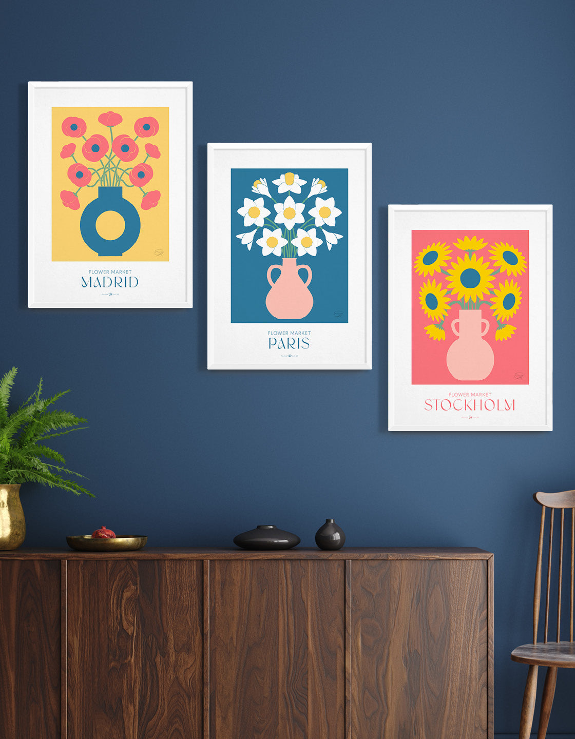 A colorful gallery wall featuring three flower market prints: daffodils, sunflowers, and poppies, each with customizable destination backgrounds.