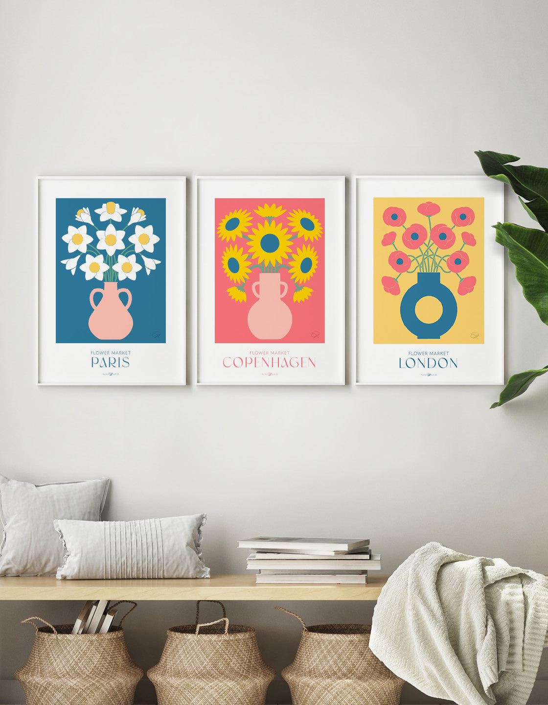 A colorful gallery wall featuring three flower market prints: daffodils, sunflowers, and poppies, each with customizable destination backgrounds.