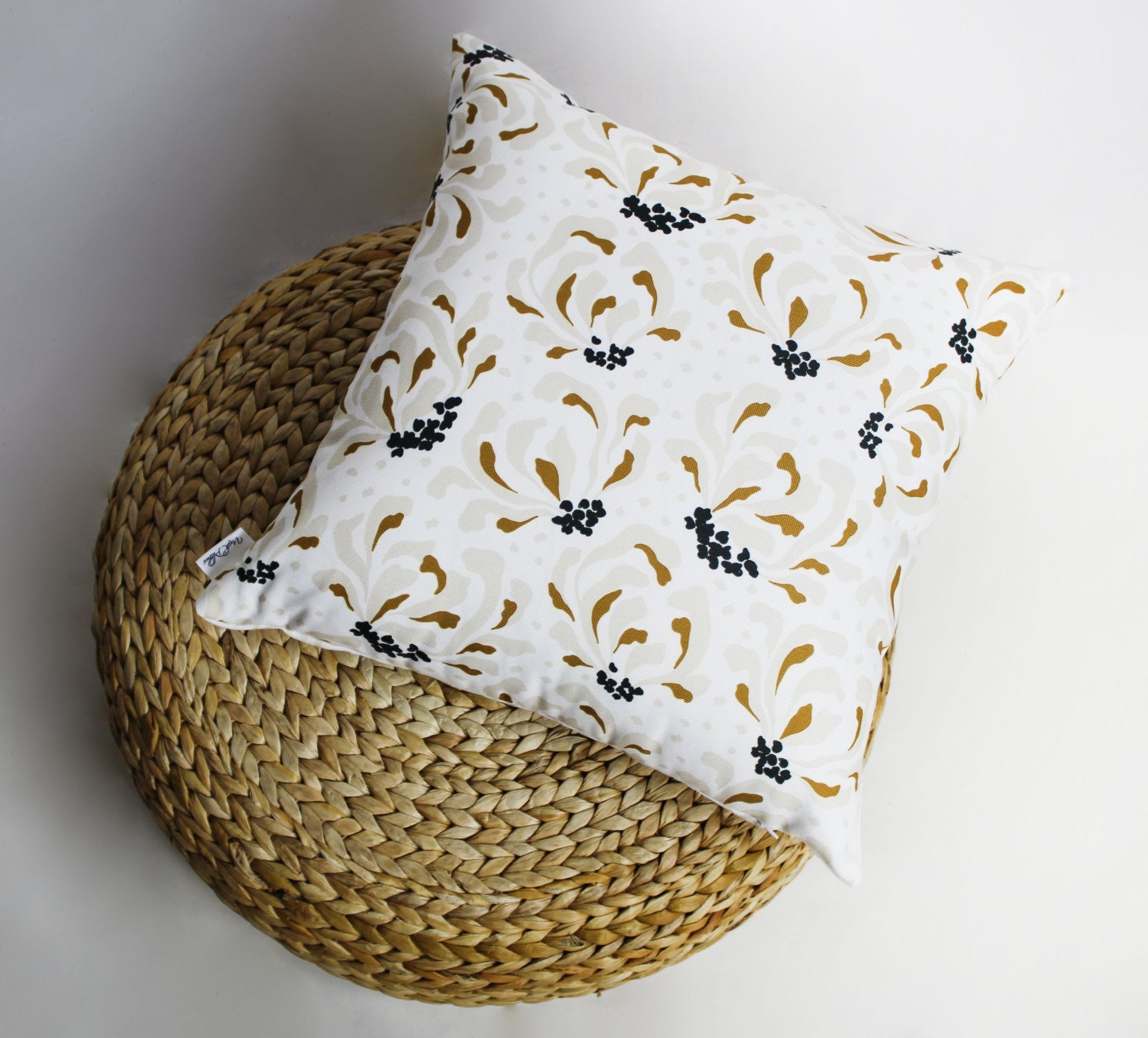 Decorative pillows with vibrant flower and sunburst patterns, showcasing a colorful design perfect for home decor.