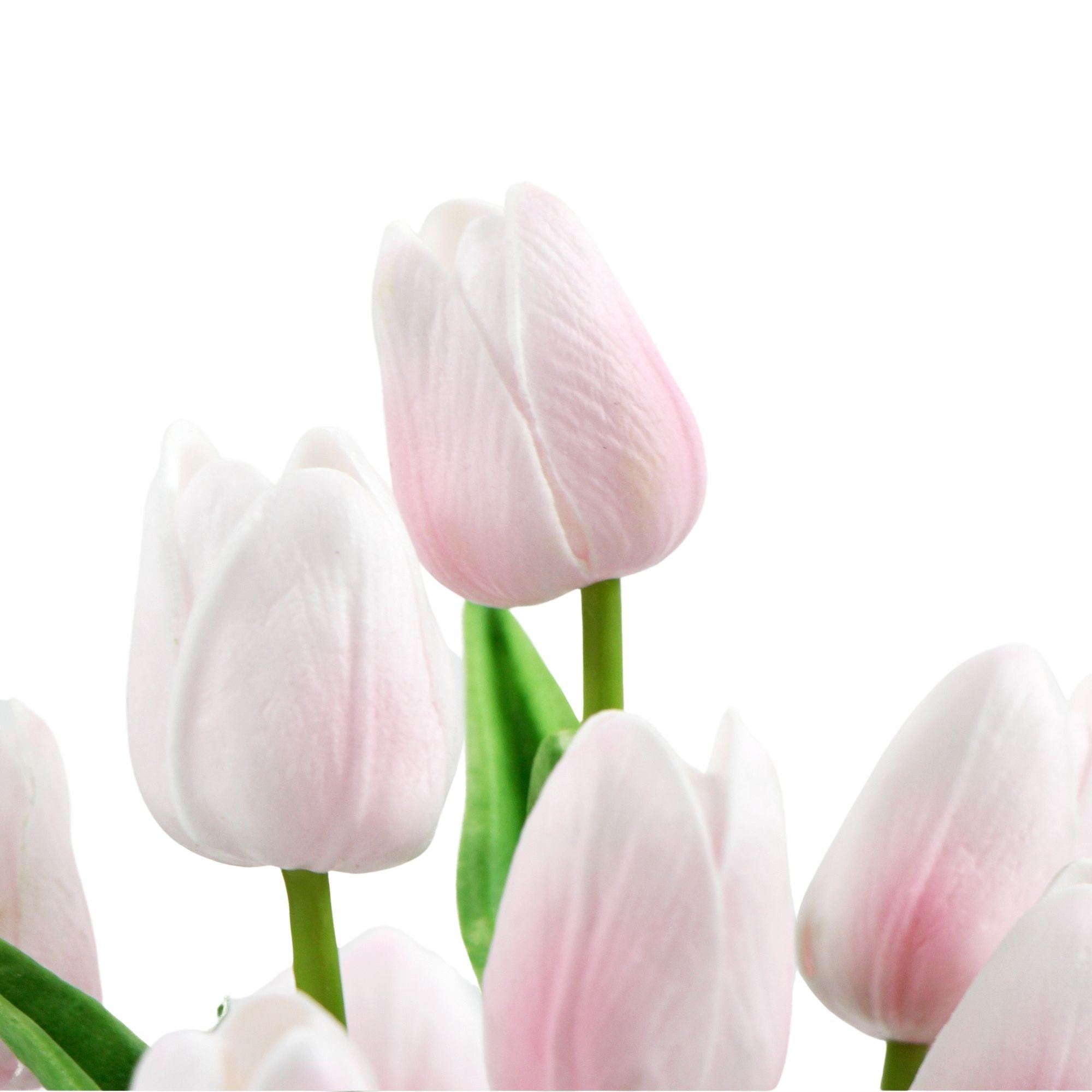 A vibrant arrangement of pink artificial tulips in a modern ceramic bowl, showcasing lush green foliage.