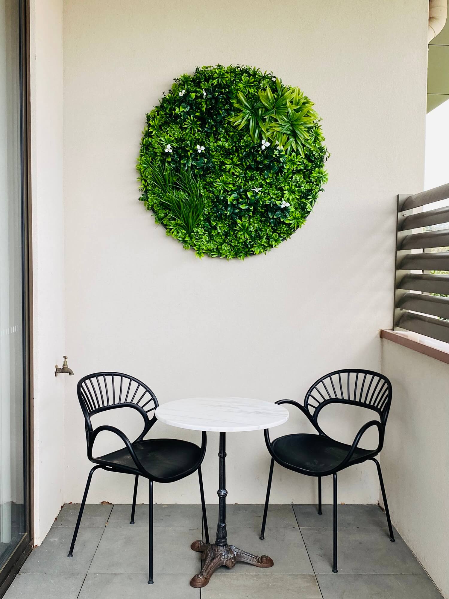 Large Flowering White Artificial Green Wall Disc with black frame, showcasing vibrant white flowers and lush greenery.