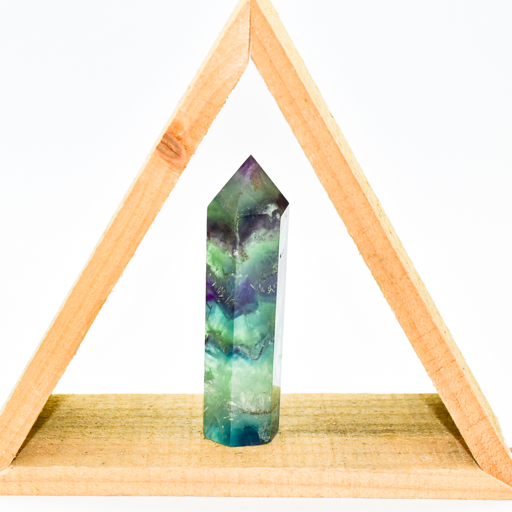 A polished Fluorite Crystal Gemstone Point, showcasing vibrant colors and unique patterns, ideal for energy cleansing and spiritual enhancement.