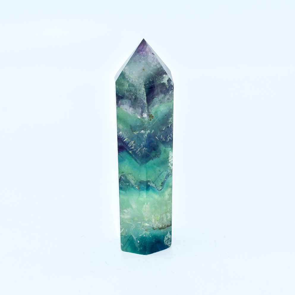 A polished Fluorite Crystal Gemstone Point, showcasing vibrant colors and unique patterns, ideal for energy cleansing and spiritual enhancement.