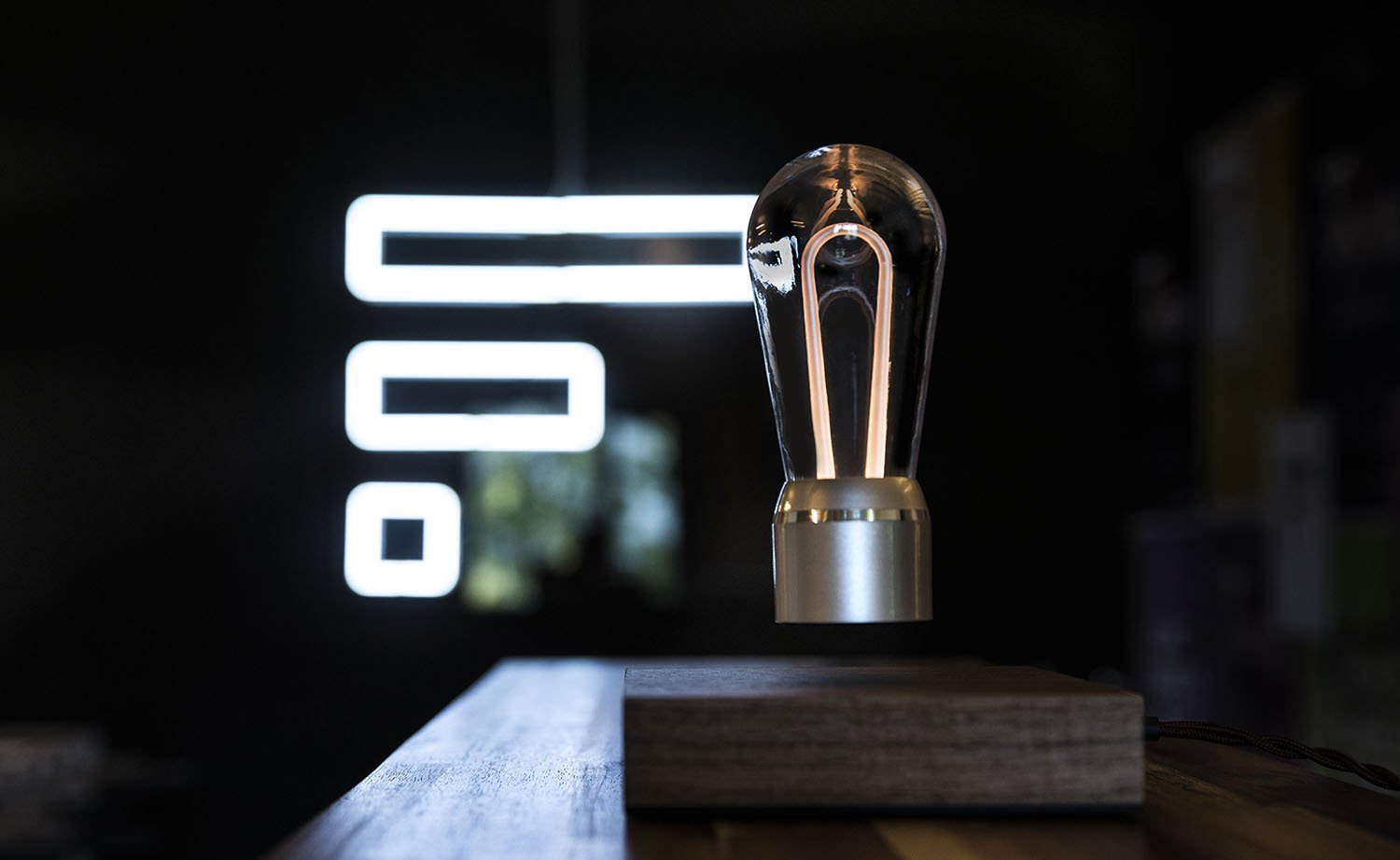 FLYTE Nikola levitating light bulb with Walnut base and Chrome Marconi bulb, showcasing innovative design and energy efficiency.