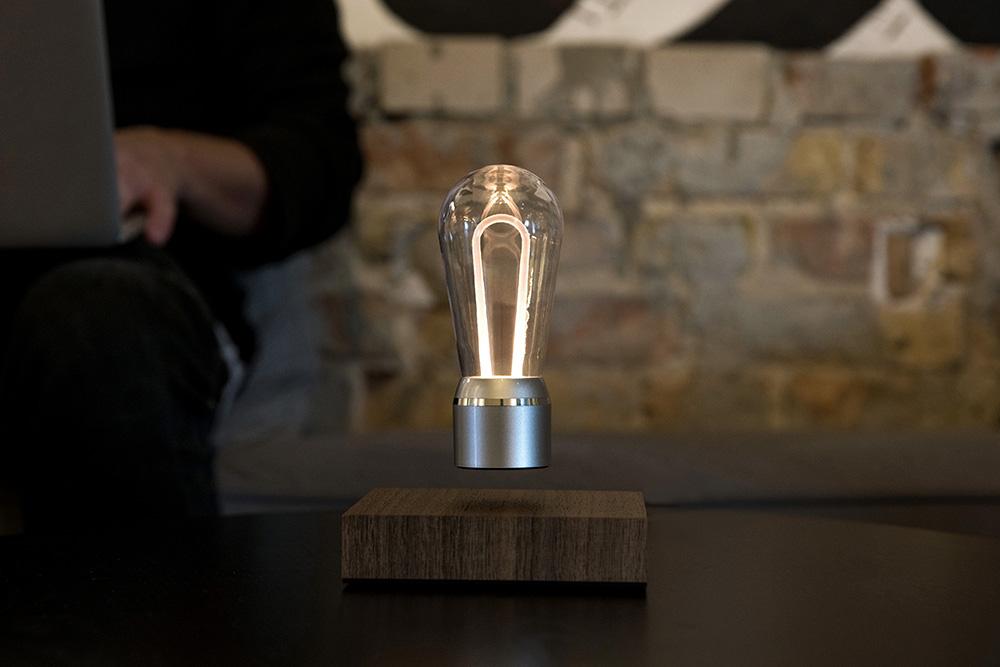 FLYTE Nikola levitating light bulb with Walnut base and Chrome Marconi bulb, showcasing innovative design and energy efficiency.