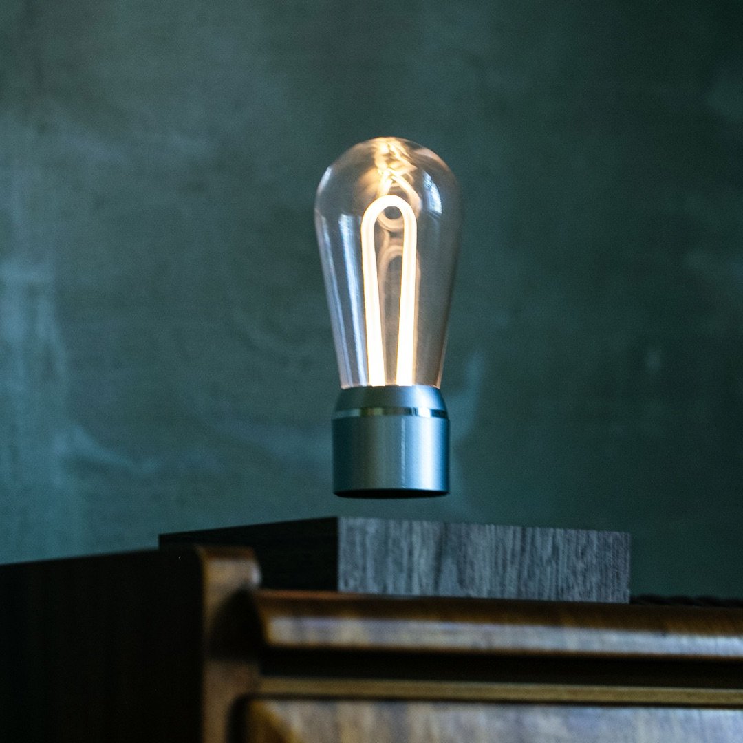 FLYTE Nikola levitating light bulb with Walnut base and Chrome Marconi bulb, showcasing innovative design and energy efficiency.