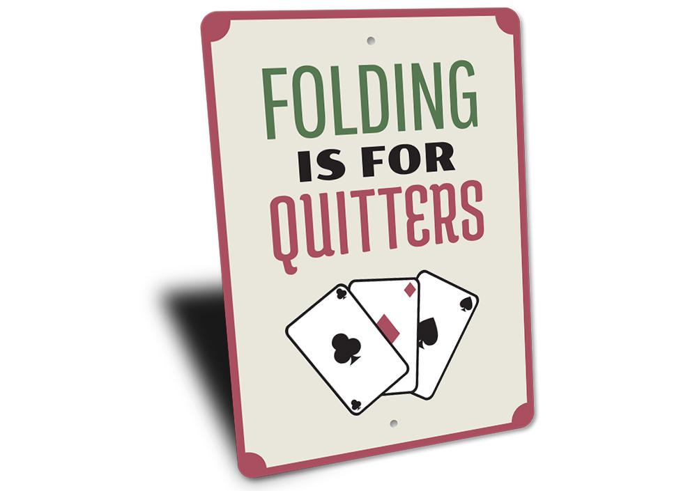 Folding is for Quitters Sign made of aluminum, featuring humorous text, perfect for home decor.