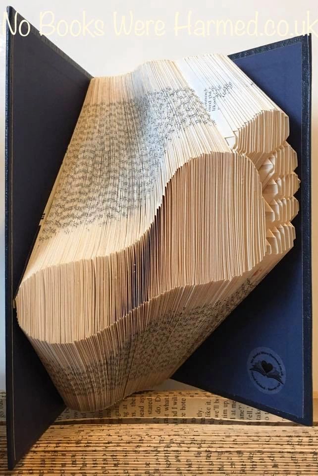 Unique footstep art made from hand-folded vintage book pages, showcasing intricate designs and eco-friendly craftsmanship.