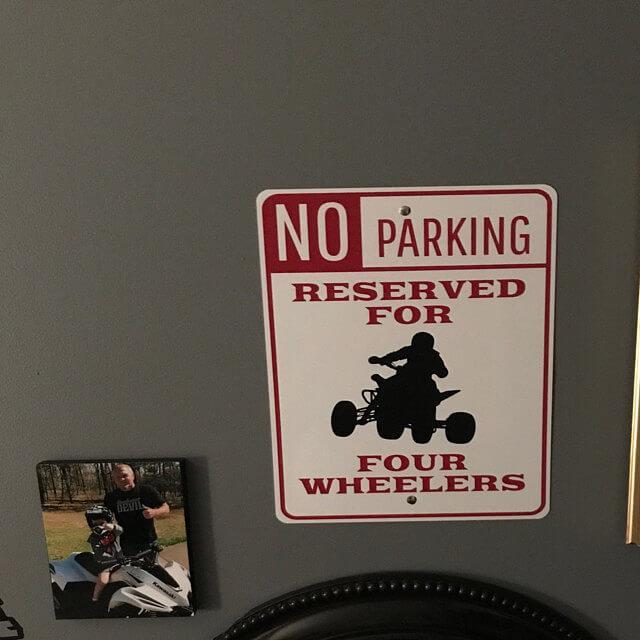 Four Wheeler Parking Sign made of high-quality aluminum with customizable text and unique designs for various vehicles.