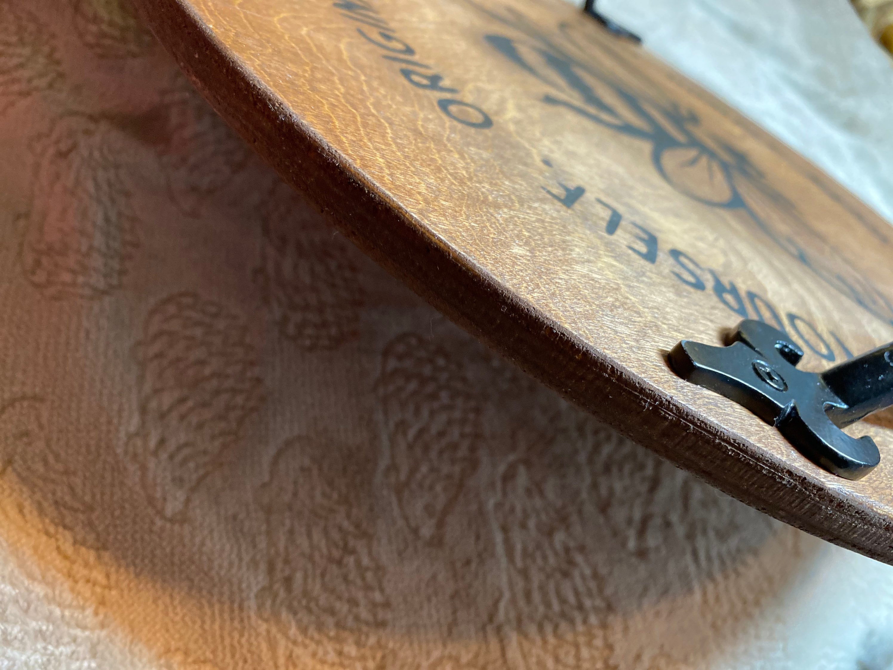 A handmade Fresh Honey Wooden Serving Tray made of birch plywood, stained in dark chestnut, featuring black metal handles.