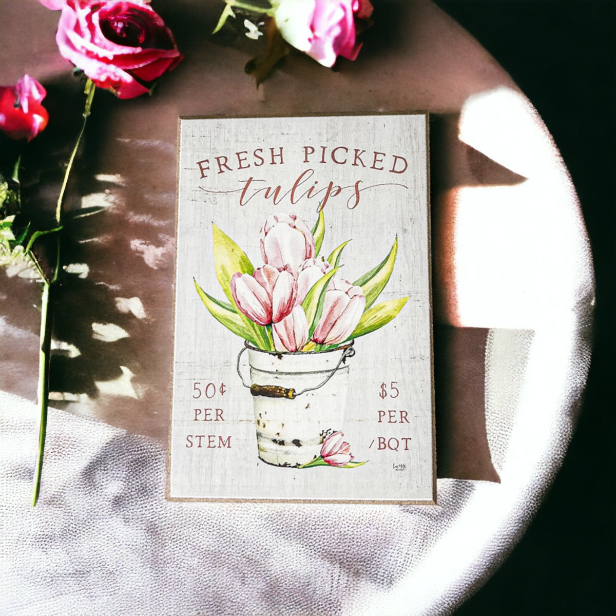 A charming wooden block sign featuring fresh tulips, perfect for spring and summer home decor.