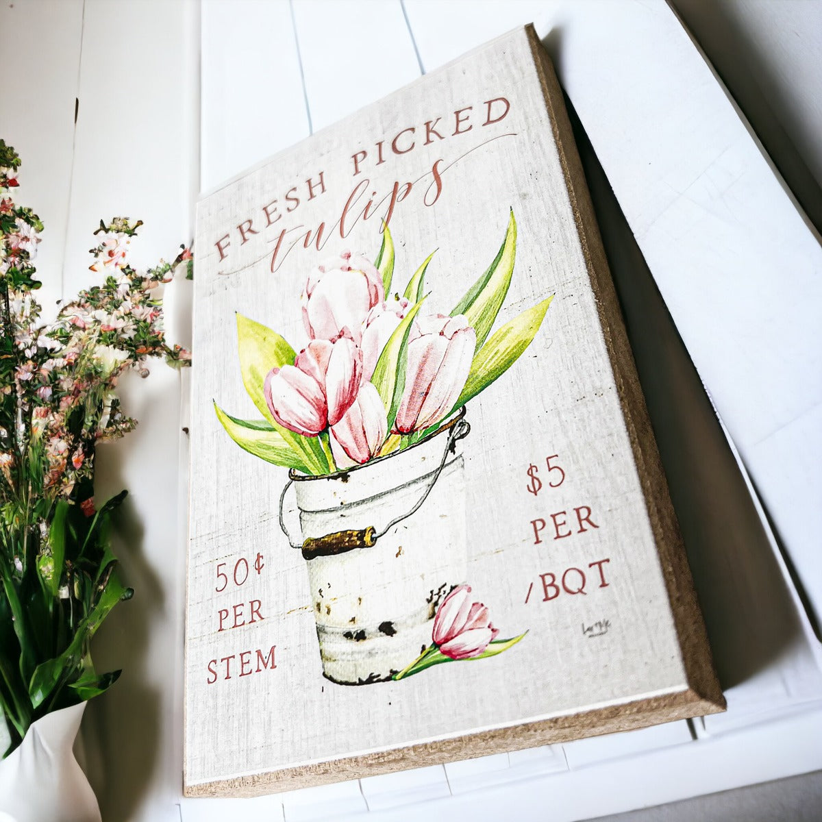 A charming wooden block sign featuring fresh tulips, perfect for spring and summer home decor.