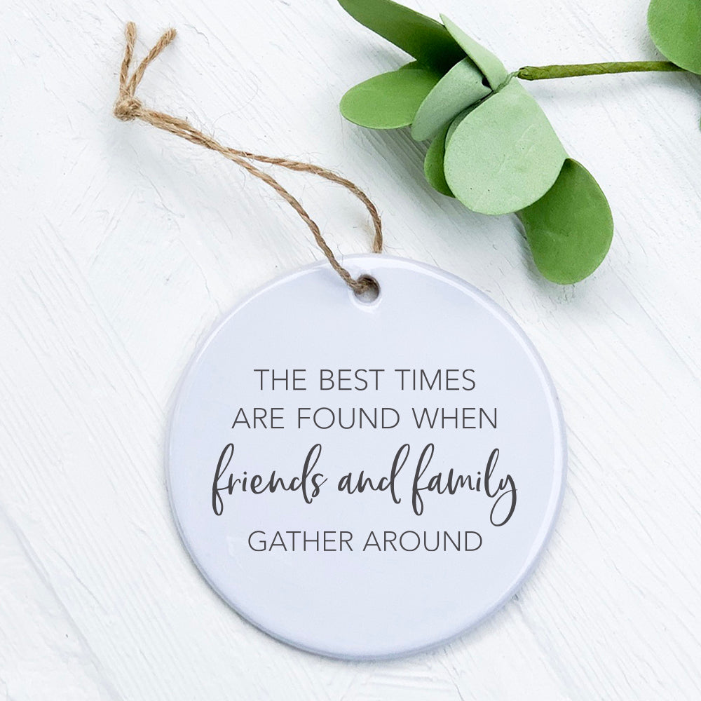 A beautifully crafted porcelain ornament featuring the phrase 'Friends Family Gather Around', showcasing vibrant colors and a smooth finish.