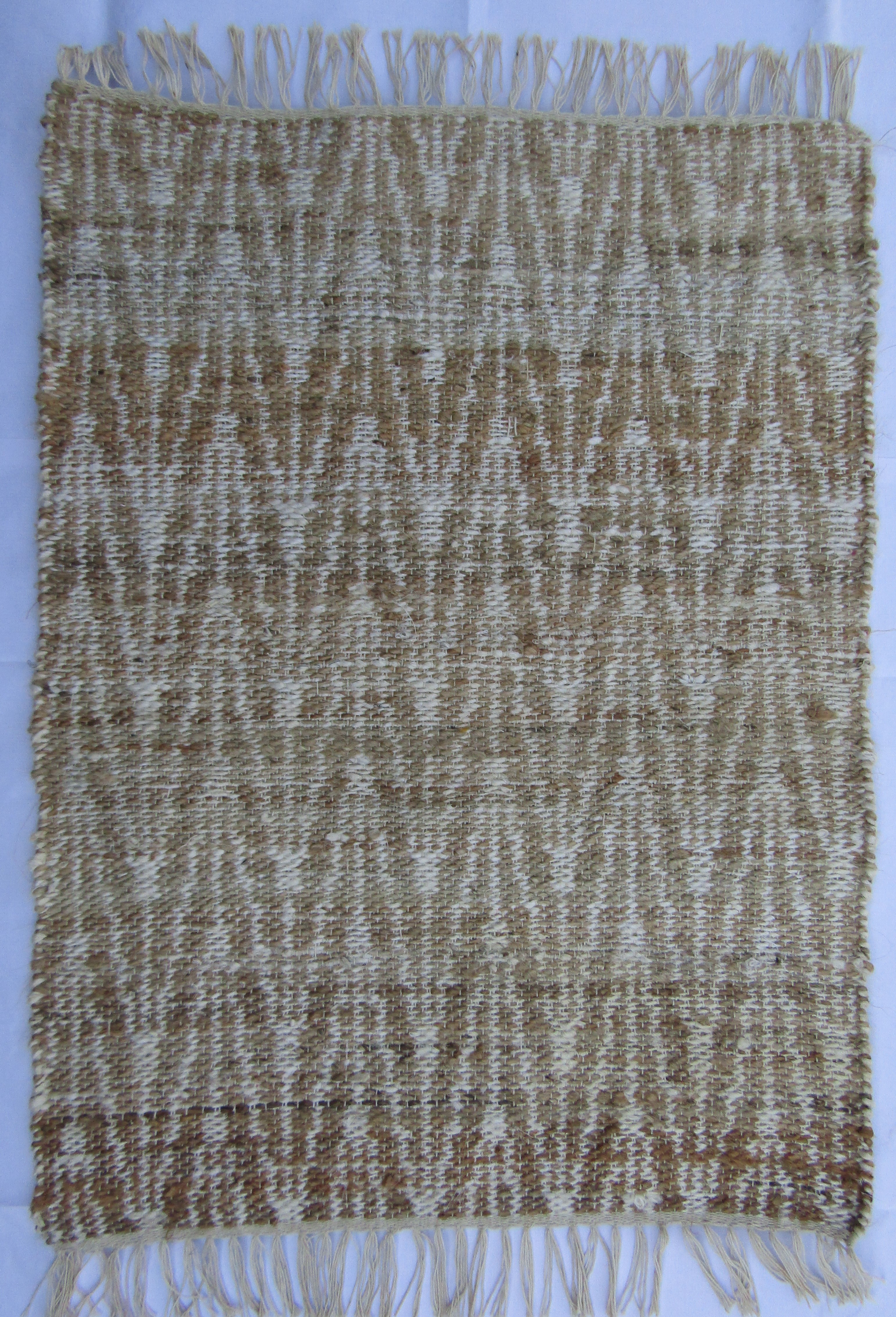 Woven rug with zigzag pattern.