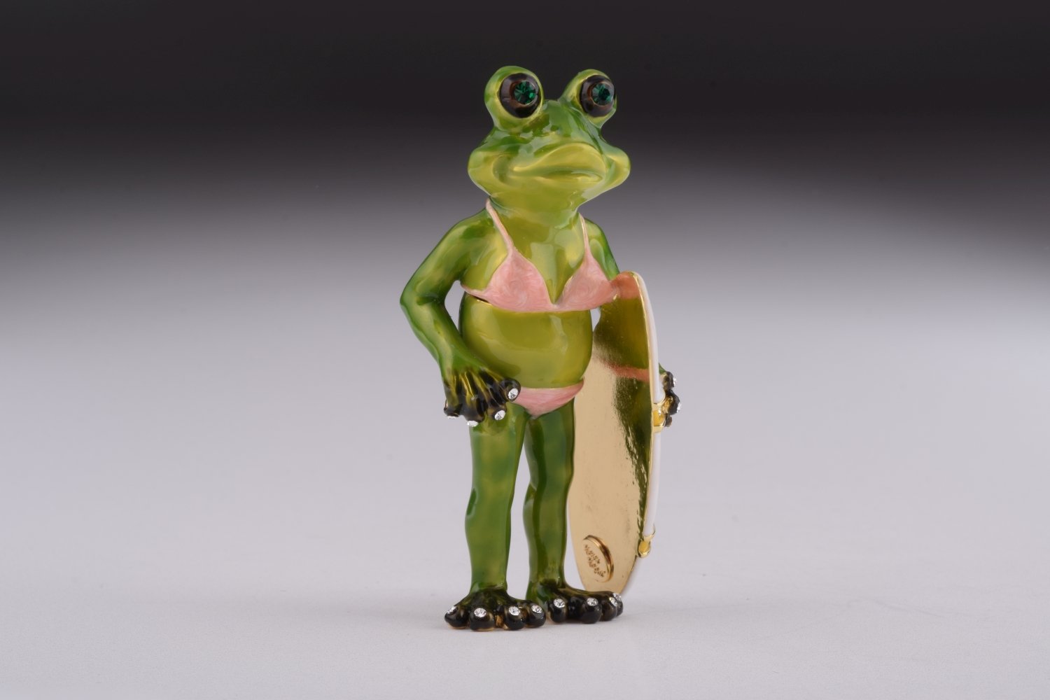 A beautifully crafted Frog Holding a Surfboard trinket box, adorned with Austrian crystals and plated with 24K gold, showcasing intricate details.