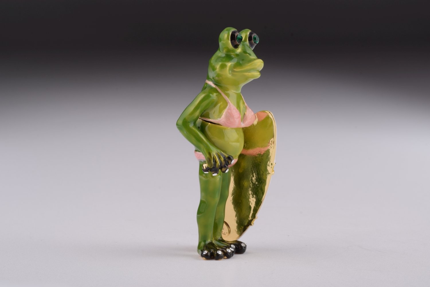 A beautifully crafted Frog Holding a Surfboard trinket box, adorned with Austrian crystals and plated with 24K gold, showcasing intricate details.