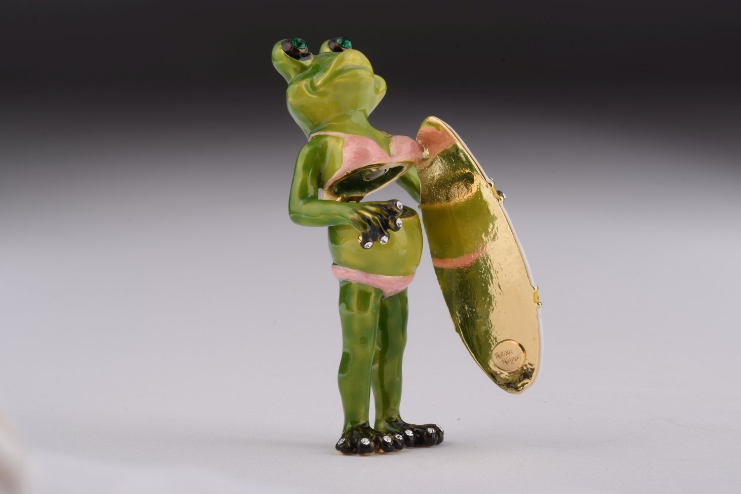 A beautifully crafted Frog Holding a Surfboard trinket box, adorned with Austrian crystals and plated with 24K gold, showcasing intricate details.