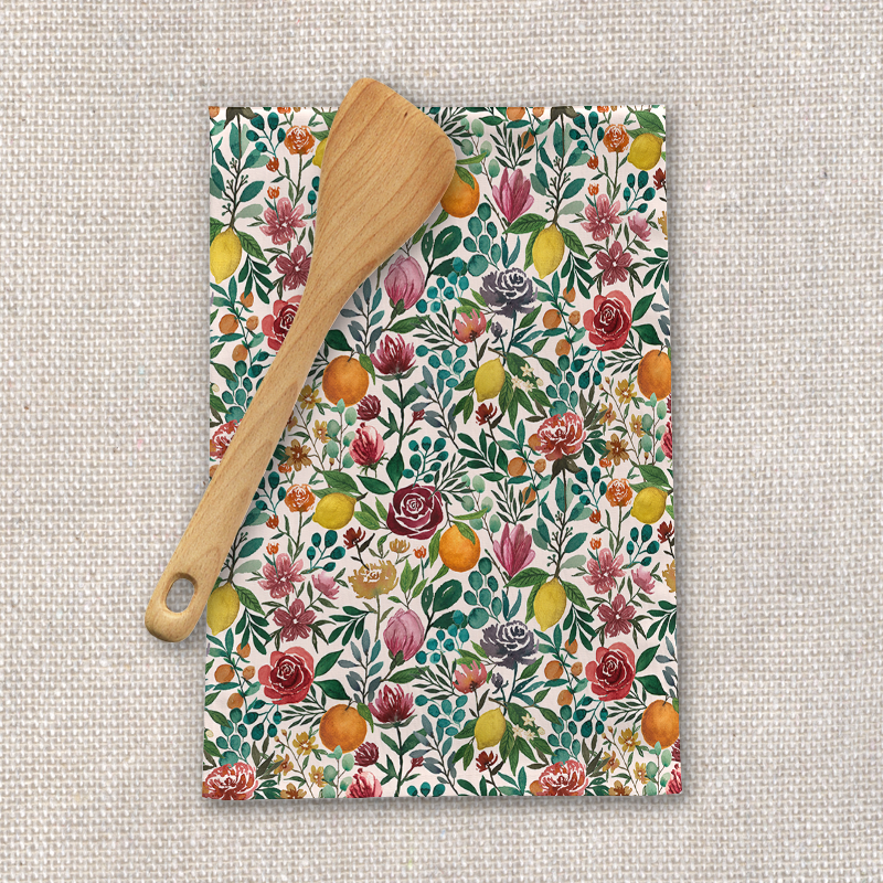 A colorful Fruit and Flowers Tea Towel made of cotton twill, featuring vibrant floral and fruit designs, perfect for kitchen use.