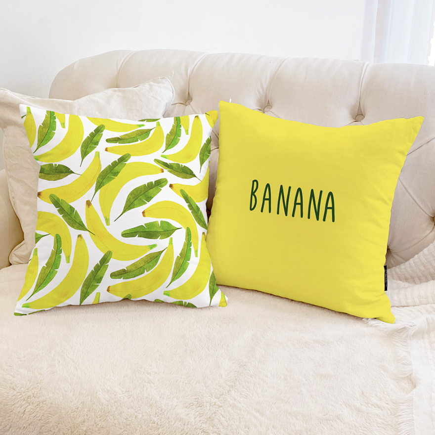 A vibrant Banana cushion featuring a double-sided design, showcasing a playful banana print and soft microfiber material.