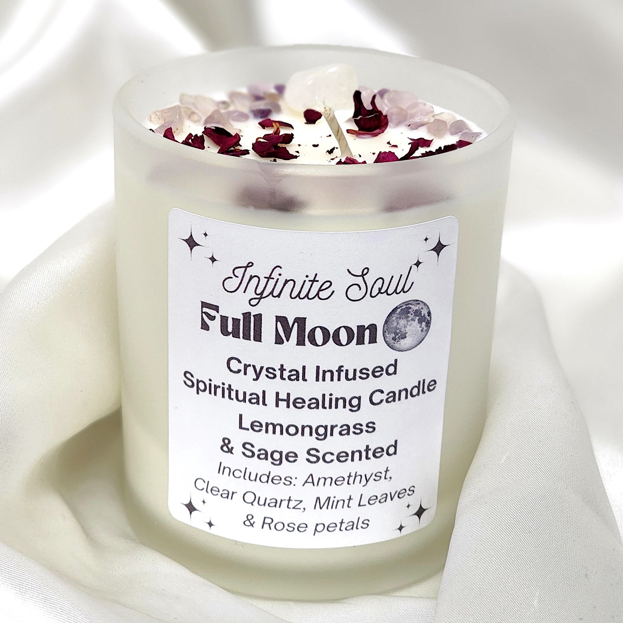 Full Moon Crystal Infused Candle with Lemongrass and Sage scent, featuring clear quartz and amethyst crystals, in a frosted jar.