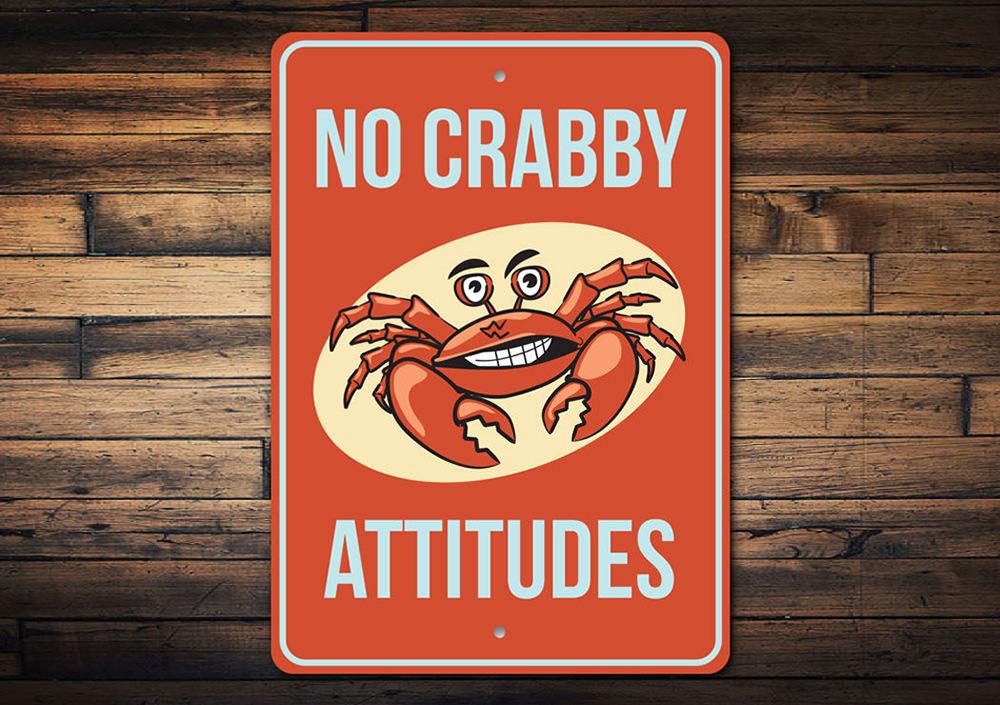 A humorous metal sign featuring a crab design, perfect for beach-themed decor, showcasing vibrant colors and a playful message.