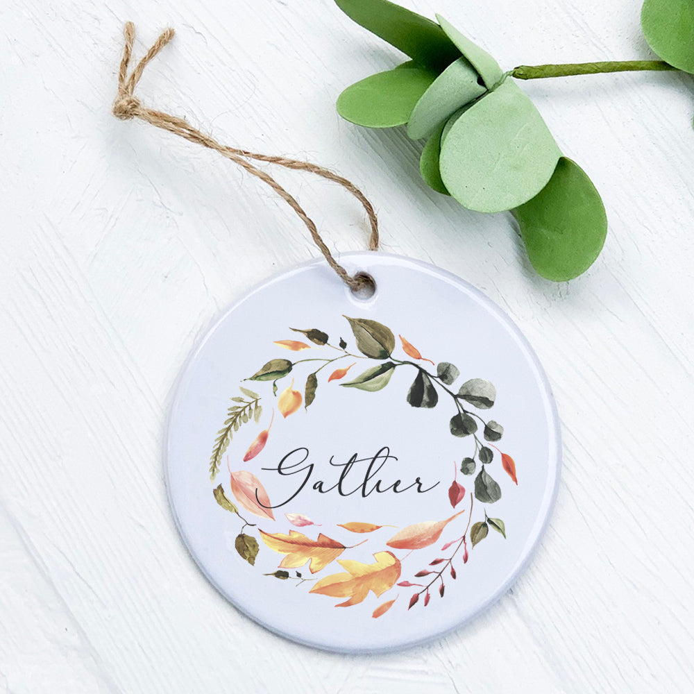 Gather Wreath Ornament made of high-quality porcelain with a vibrant design, perfect for holiday decor or as a gift tag.