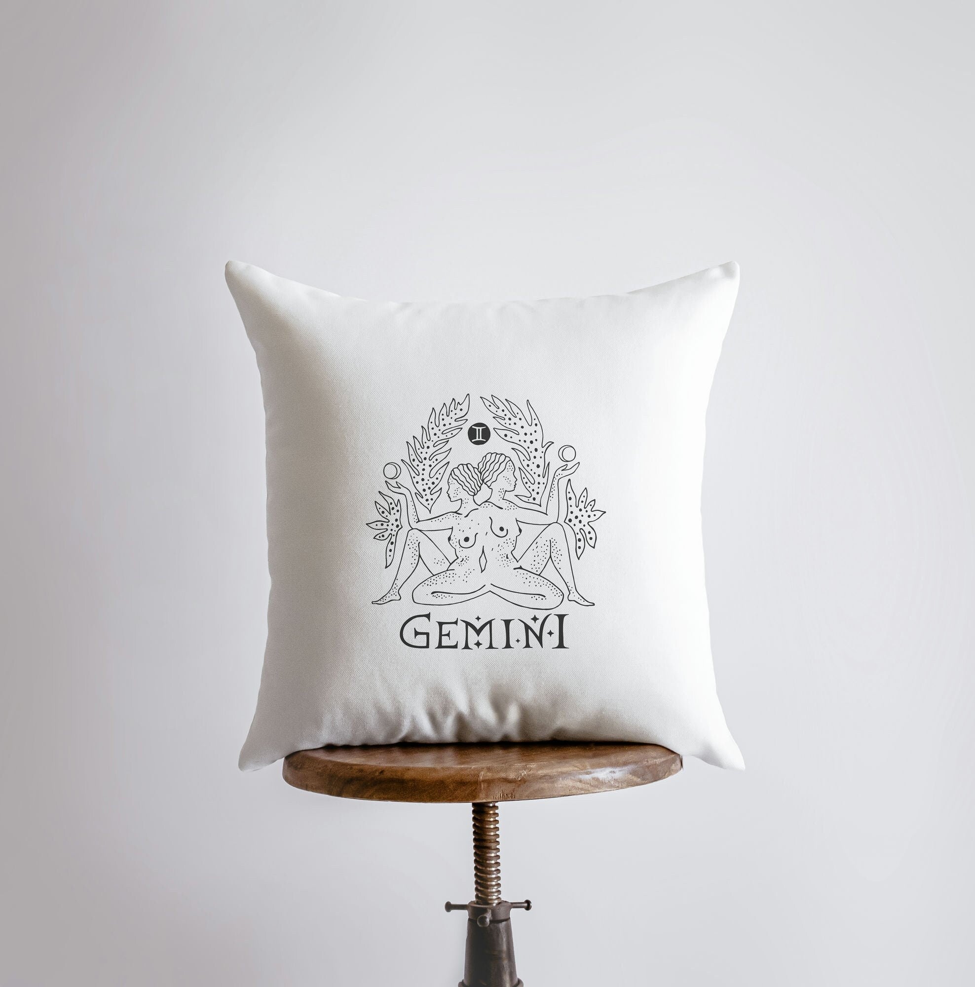 Gemini Zodiac Throw Pillow featuring the Gemini symbol on the front, handcrafted in America with a concealed zipper and available in various sizes.