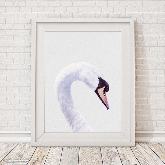 Framed swan painting on wall.