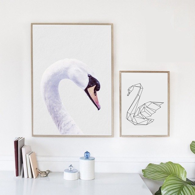 Two swan-themed framed artworks.