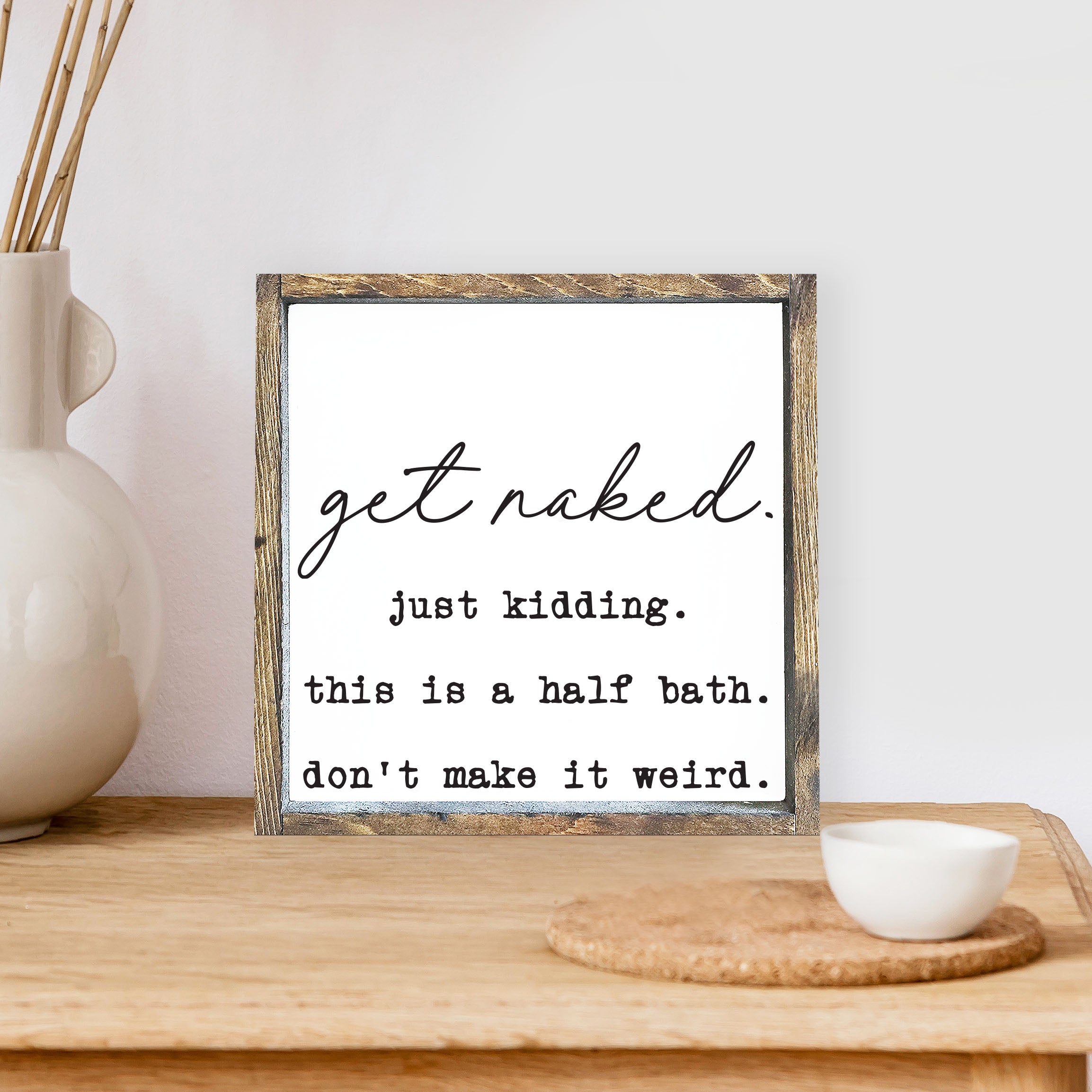 Get Naked, Just Kidding Wood Sign with a humorous message, framed in stained pine wood, perfect for bathroom decor.