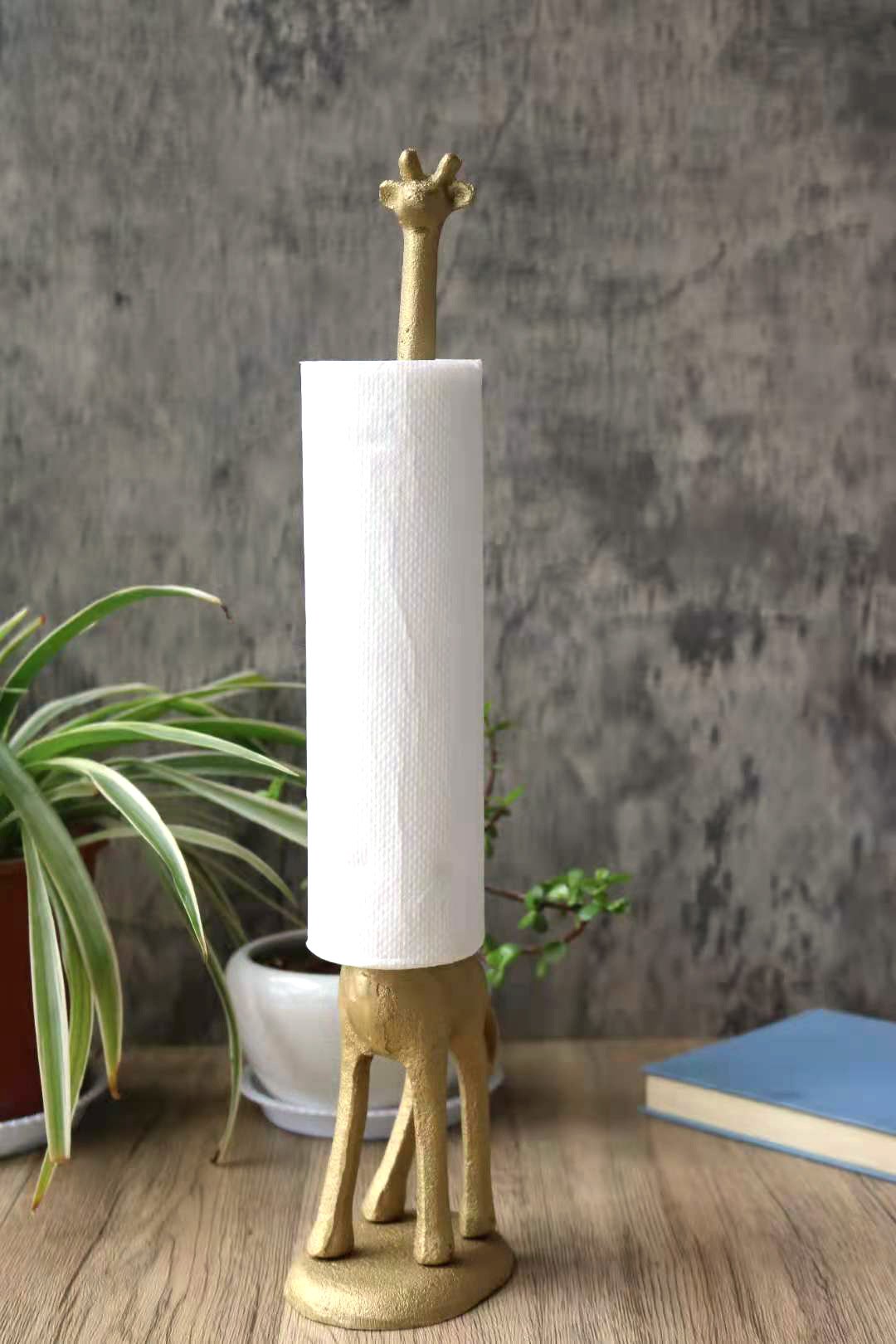 Handmade gold cast iron giraffe paper towel holder, featuring a detailed giraffe design with a tall neck, perfect for kitchen or bathroom use.