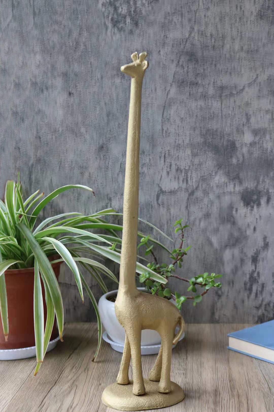 Handmade gold cast iron giraffe paper towel holder, featuring a detailed giraffe design with a tall neck, perfect for kitchen or bathroom use.