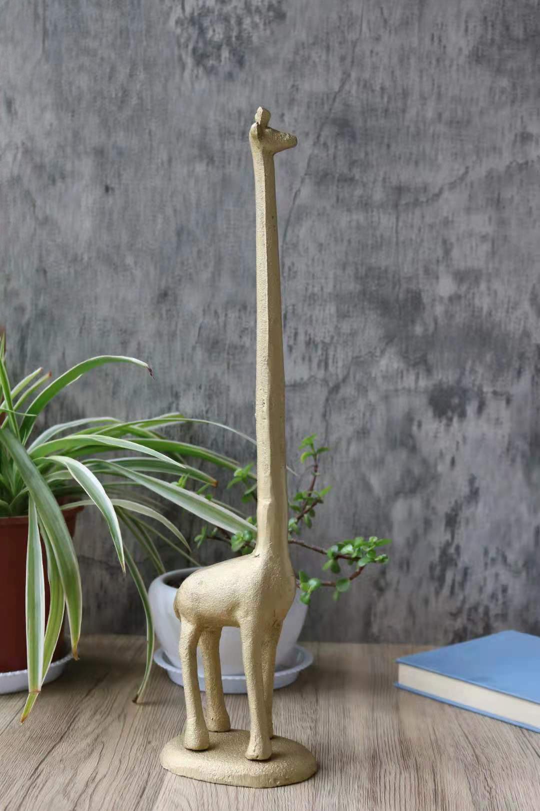 Handmade gold cast iron giraffe paper towel holder, featuring a detailed giraffe design with a tall neck, perfect for kitchen or bathroom use.