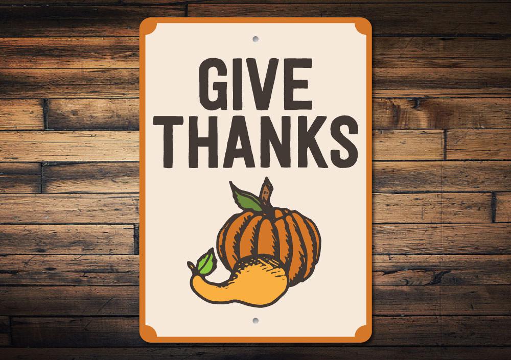 A decorative Give Thanks Pumpkin Sign made of high-quality aluminum, featuring a vibrant pumpkin design perfect for home decor.