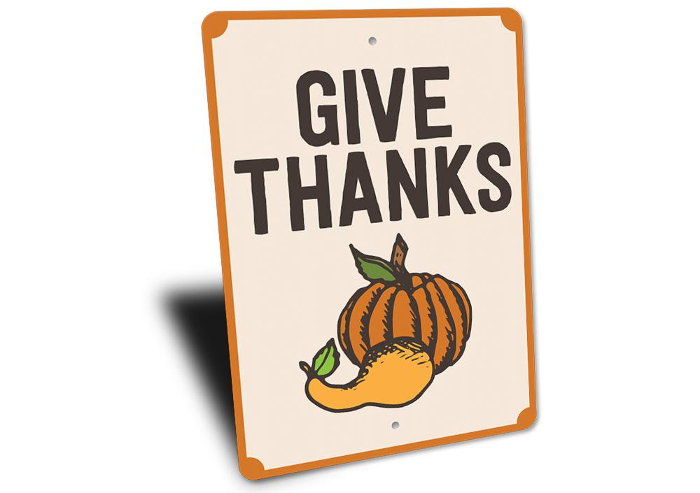 A decorative Give Thanks Pumpkin Sign made of high-quality aluminum, featuring a vibrant pumpkin design perfect for home decor.