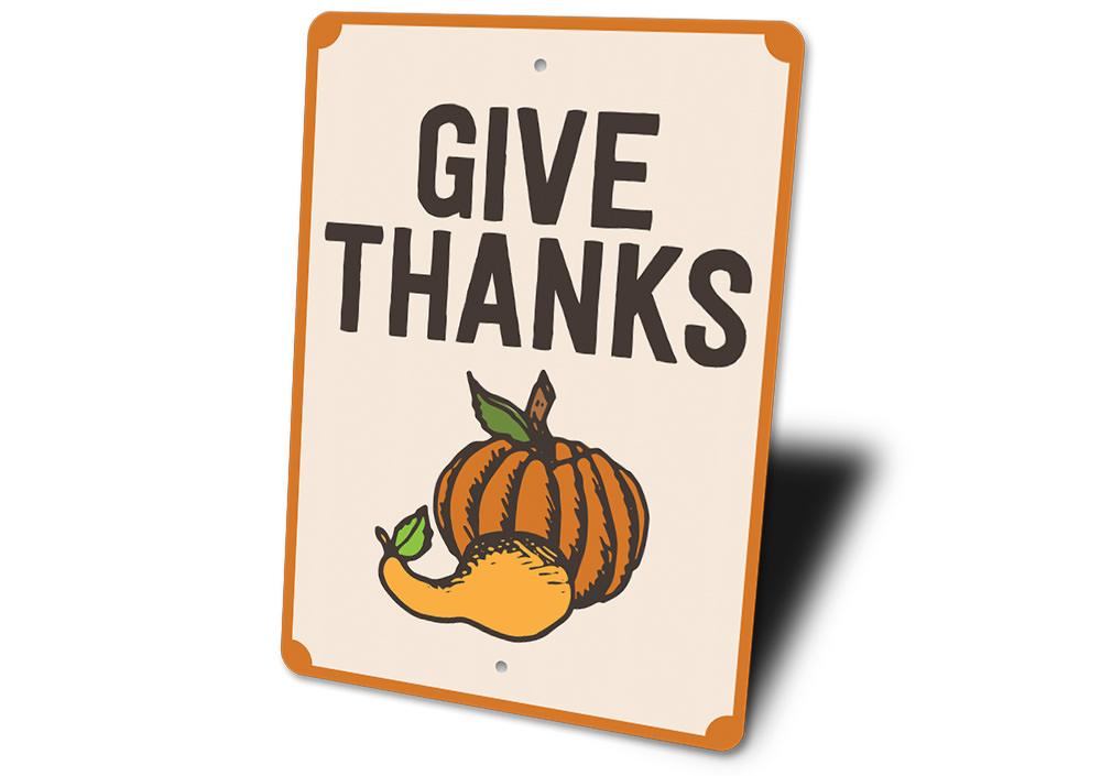 A decorative Give Thanks Pumpkin Sign made of high-quality aluminum, featuring a vibrant pumpkin design perfect for home decor.